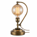 Vintage Edison bulb table lamp with antique brass base and warm amber filament glow